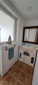 a bathroom with a sink and a mirror at Casa Isleta in La Manga del Mar Menor +29 photos