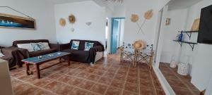 a living room with a couch and a table at Casa Isleta in La Manga del Mar Menor
