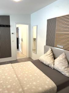 a bedroom with a large bed and a mirror at Messe 3 Minutes in Hannover