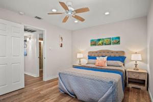 a bedroom with a bed and a ceiling fan at Fish Station Bike Rack BBQ Golf Cart Access in Port Aransas