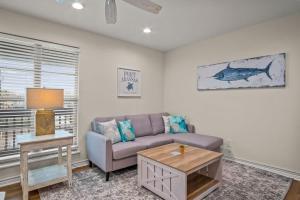 a living room with a couch and a table at Fish Station Bike Rack BBQ Golf Cart Access in Port Aransas