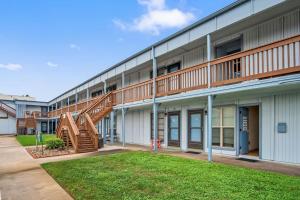a building with a staircase on the side of it at Fish Station Bike Rack BBQ Golf Cart Access in Port Aransas