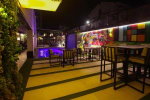 a restaurant with tables and chairs and a mural at Monarch Hotel Amman in Amman