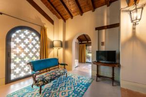 a living room with a chair and a television at Case Zucchi Bioagriturismo in Castelnuovo Fogliani