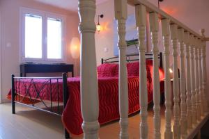 a bedroom with a bed with a red blanket at Artistic Sea View House in Corfu