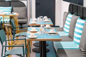 a row of tables and chairs in a restaurant at Occidental Las Canteras in Las Palmas de Gran Canaria