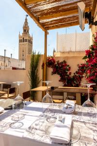 a table with glasses and napkins on top of a building at Arco de la Seda - Hotel Boutique in Seville