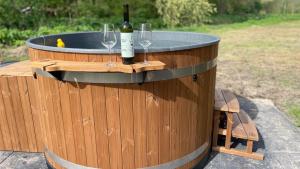 a barrel with two wine glasses and a bottle of wine at The Unbound Amsterdam in Amsterdam