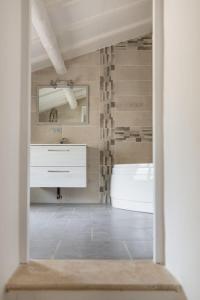 a bathroom with a sink and a mirror and a tub at Évasion de charme, maison authentique et spa privé in La Baume-de-Transit +54 photos