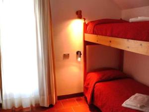 a bedroom with two bunk beds and a window at Cervinia Due in Breuil