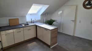 an attic kitchen with a sink and a window at FeWo 2 - Deidesheim in Deidesheim