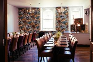 a dining room with a long table and chairs at The Duke of Edinburgh Hotel & Bar in Barrow in Furness