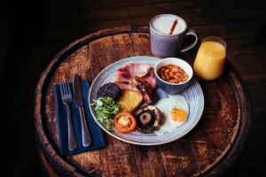 a plate of breakfast food on a wooden table at The Duke of Edinburgh Hotel & Bar in Barrow in Furness
