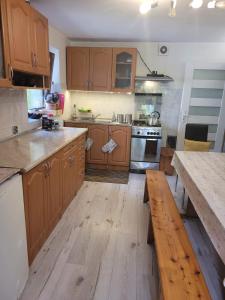 a kitchen with wooden cabinets and a wooden counter top at Agroturystyka Oblica in Zawoja