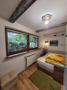 a bedroom with a bed and a window at Agroturystyka Oblica in Zawoja