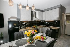 a kitchen with a table with fruits and vegetables on it at Bay Maisonette in Iraklitsa