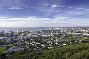 a view of a city from a hill with the ocean at Captivating 1-Bed Apartment in Swansea in Swansea