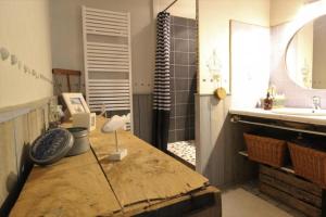 a bathroom with a wooden table and a sink at Jallanges in Fontevraud-l'Abbaye