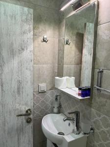 a bathroom with a sink and a mirror at Tiana Butik Otel in Bodrum City