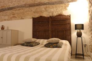 a bedroom with a large bed with two pillows at Le Badesse Mitrate by il pumo di puglia in Conversano