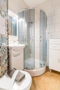 Un baño con ducha, inodoro y lavabo. en Szeroka Royal Rooms, en Gdansk