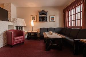 a living room with a couch and a fireplace at Fanitullen Apartments in Hemsedal