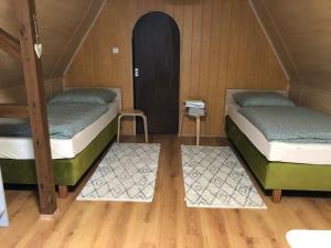 two bunk beds in a room with wooden floors at Ferienhaus Plöwen MV 