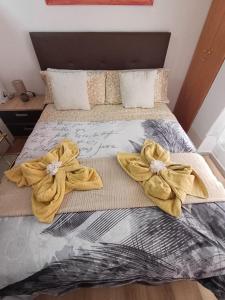 a bed with two towels on top of it at Alicante Denia Apartments in Alicante