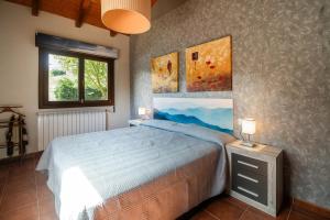 a bedroom with a bed and two paintings on the wall at Villa La Marquesa de Llanes in Llanes