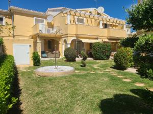 a large house with a yard in front of it at Aldea del Mar II in Els Poblets