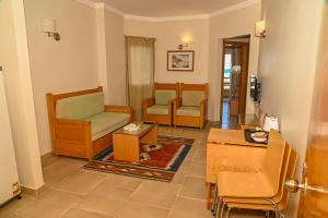a living room with two chairs and a table at Eagles down town Zahabia &Beach Resort in Hurghada