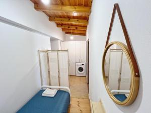 a small room with a mirror and a blue bed at Leonidas' Guest House in Neokhórion