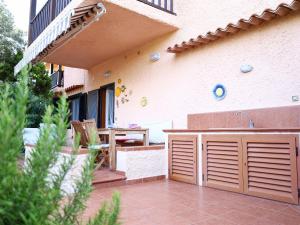 a patio of a house with a sink and a table at Comfy Flat W/ Pool, Tennis Court & Private Beach! in Porto Conte