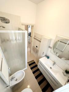 a bathroom with a shower and a sink and a toilet at Giardino al mare in Rimini