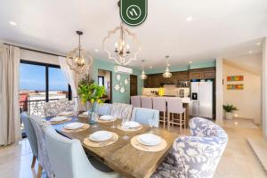 a dining room and kitchen with a table and chairs at Copala at Quivira 71 in Cabo San Lucas