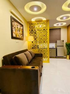 a living room with a couch in a room at Bahria Town Lahore - NEXT INN Two Bedroom condo with free parking 203 in Lahore