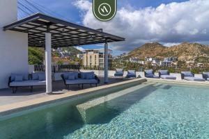 een zwembad met stoelen en een prieel bij Amazing 2BR Condo with Terrace Overlooking the Marina in Cabo San Lucas