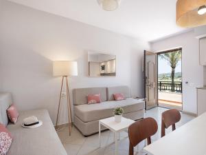 a living room with a couch and a table at Caldera Beach in Plataniás