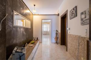 a hallway of a home with a sink and a mirror at Aia Lucia B&B in Giurdignano