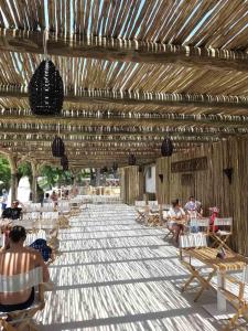 a group of people sitting in chairs under a wooden pavilion at Studio Una, 150m from the sea, parking, Crikvenica, Dramalj in Dramalj