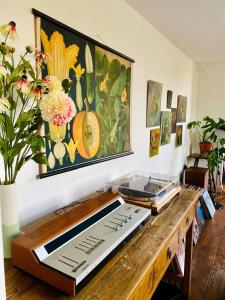 a wooden table with a cutting board and flowers on a wall at Tin tabernacle perfect for group getaways in Chale