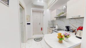 a white kitchen with flowers on a counter at Vesuvius Home in Naples