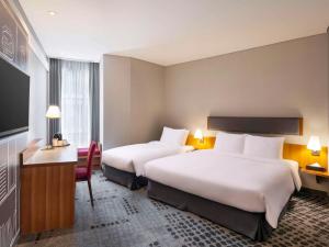 Postel nebo postele na pokoji v ubytování Ibis Ambassador Myeongdong + 37 fotografií