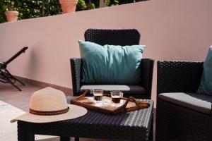 a hat and glasses on a table on a patio at Le Rondinelle Rooms in Procida