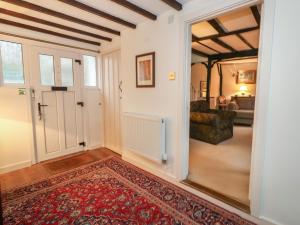 a hallway with a door leading to a living room at Poppy Cottage in Beaminster
