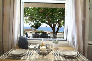 una mesa con una vela delante de una ventana en Lavi view apartment, en Lentas