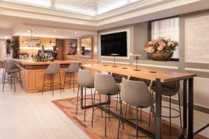 a large kitchen with a large wooden table and stools at Catalonia Las Cortes in Madrid +34 photos