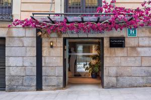 a store front with pink flowers on a building at Catalonia Las Cortes in Madrid