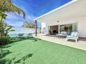 a white house with a lawn and a pool at Villa Elisa - 3510 in Mar de Cristal