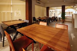 a dining room with wooden tables and chairs at Hamasville Boutique Hotel in Abuja